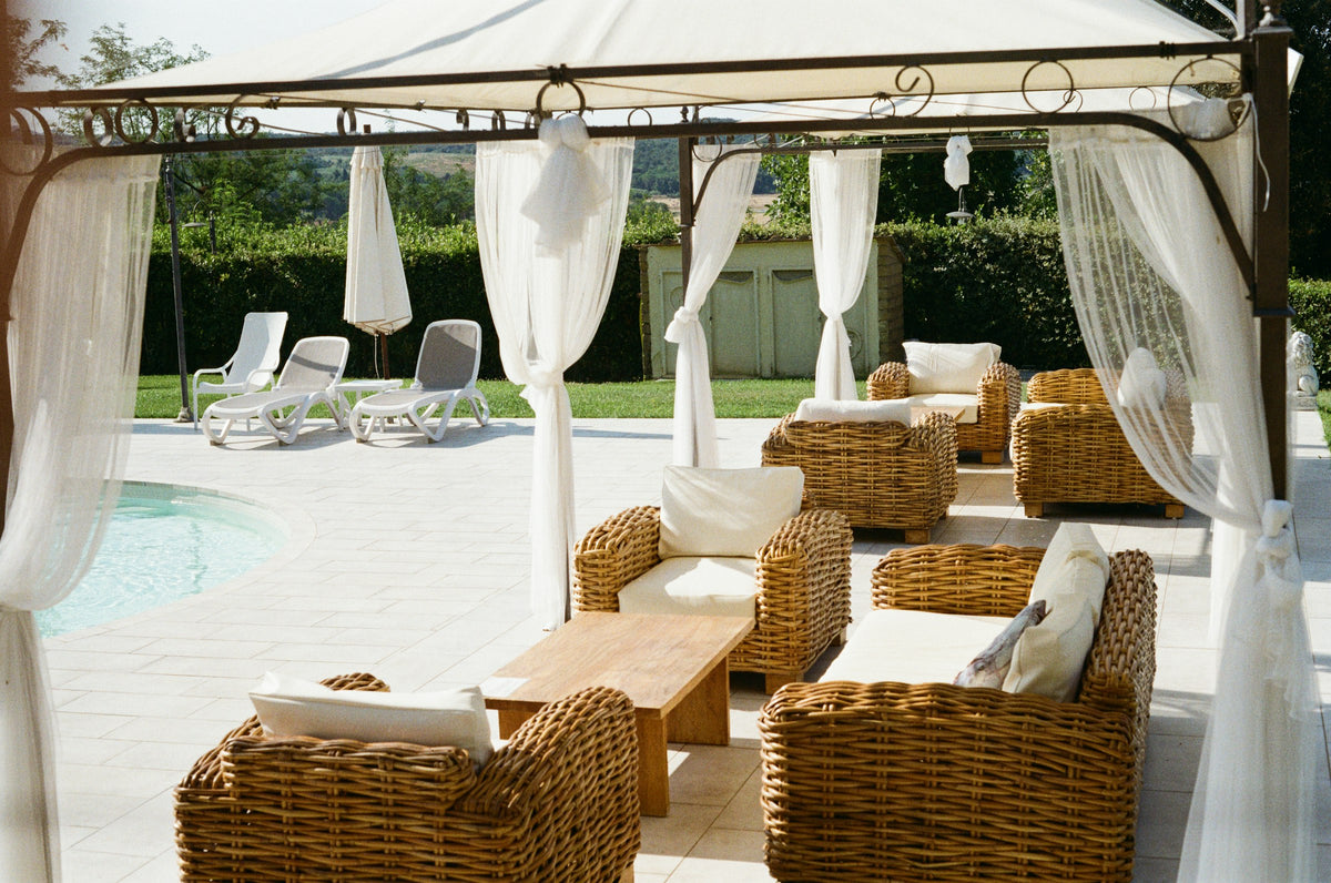 Elegant outdoor lounge with wicker seating by a pool